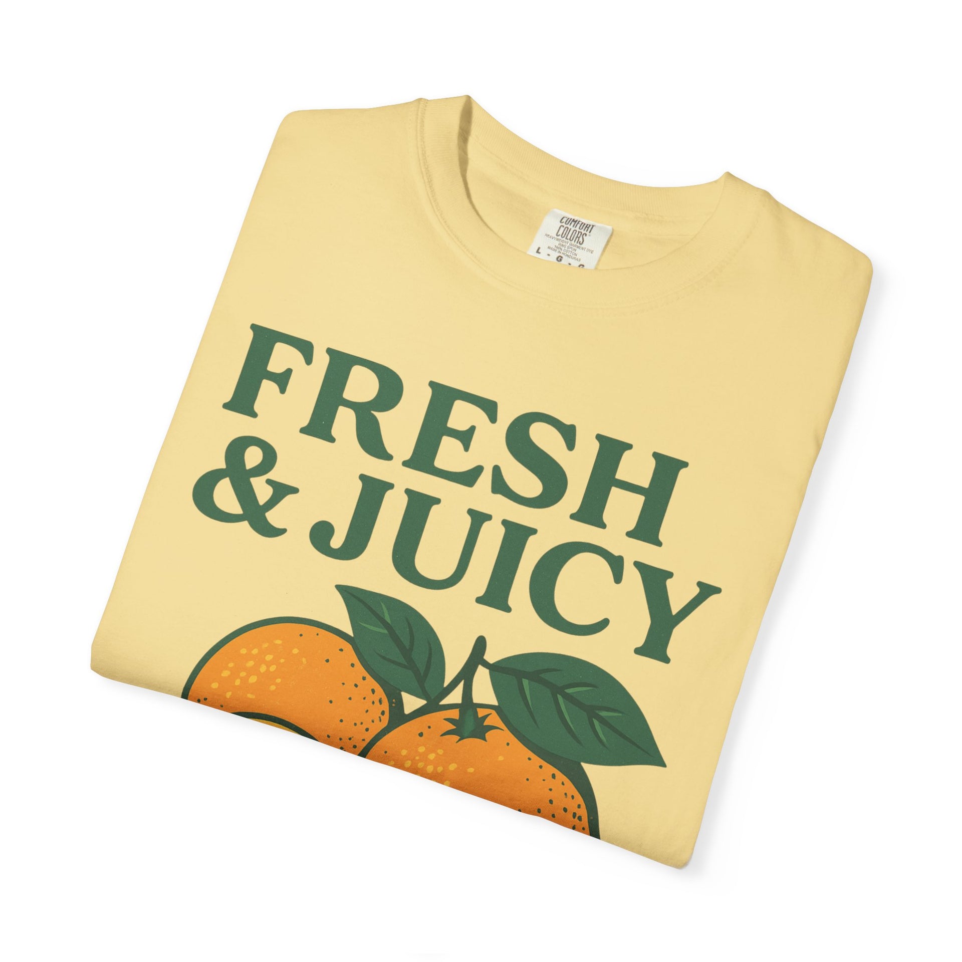 Light yellow Fresh and Juicy Oranges T Shirt folded with retro orange illustration