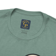 Mountain minimalist t-shirt folded on green surface with visible collar label