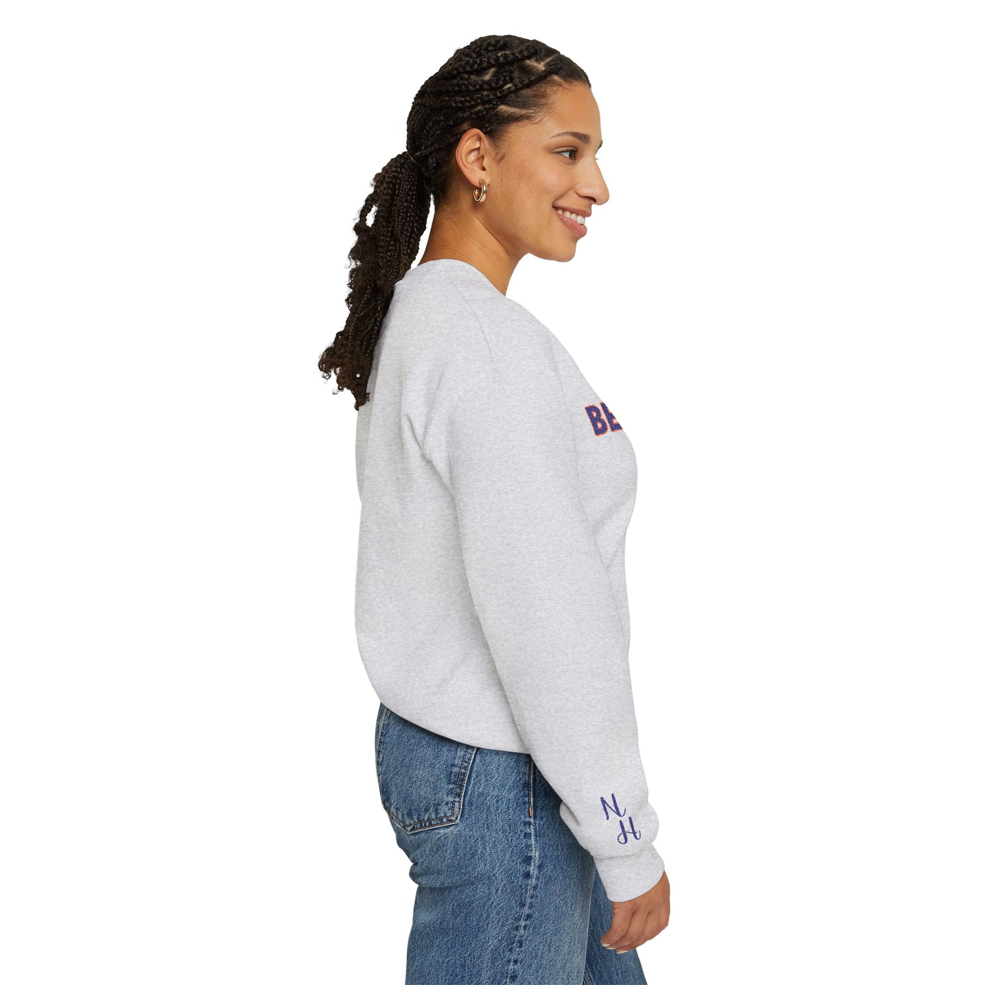 Woman wearing sand-colored Embroidered Motivational Sweatshirt, side profile